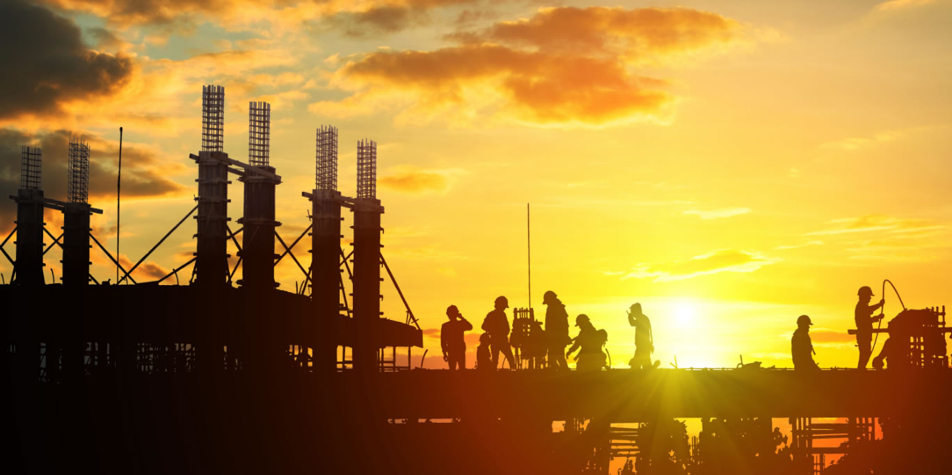 Construction workers silhouetted