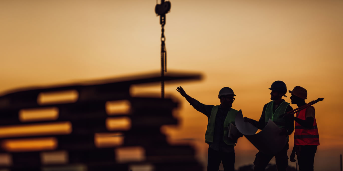 Silhouetted construction workers